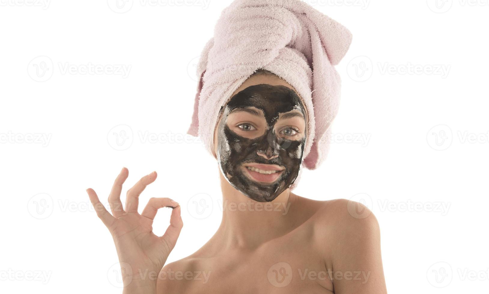 Beautiful girl with black facial cosmetic mask. Beauty concept. isolated photo