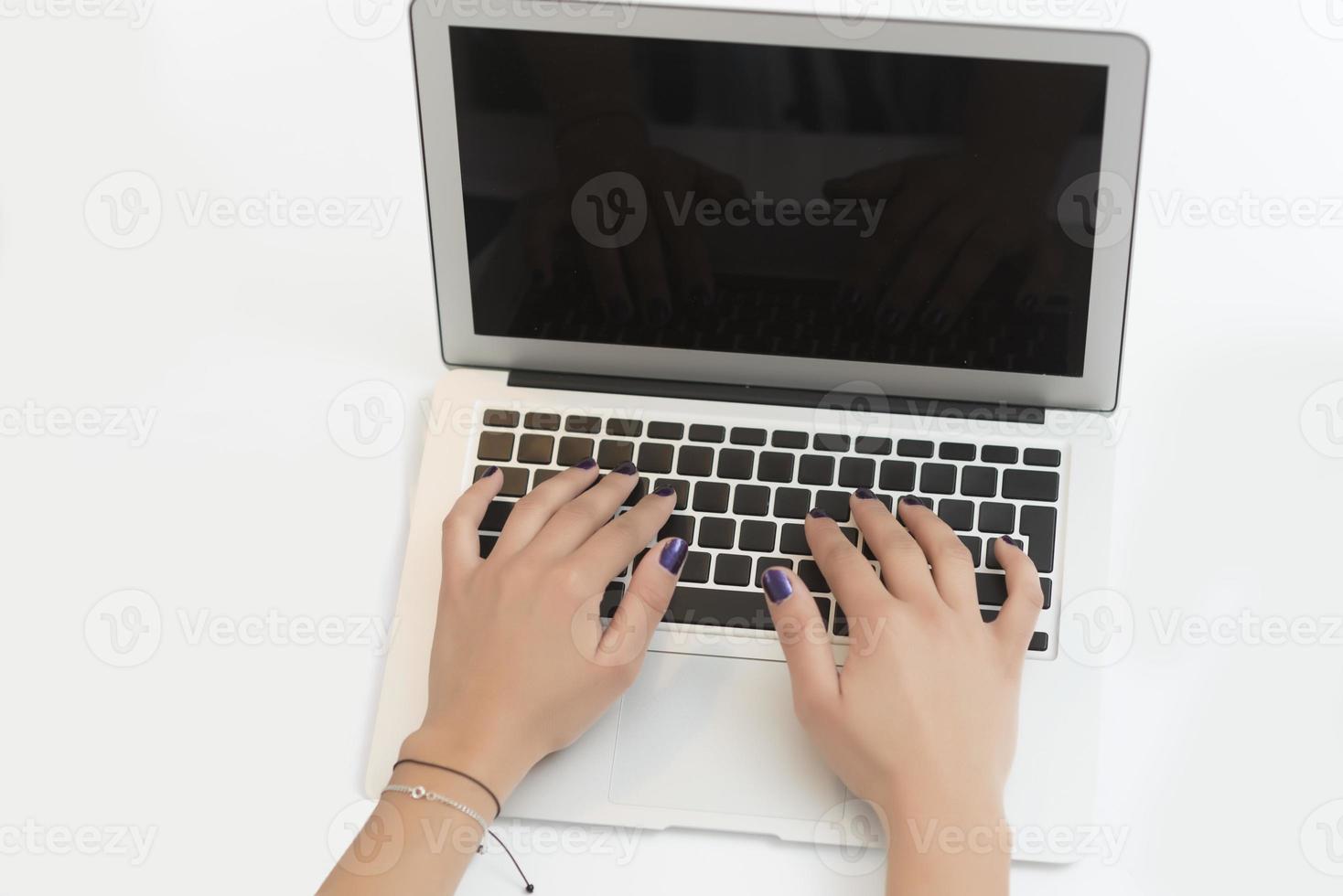 hands typing on a laptop on a office desk. Business concept photo