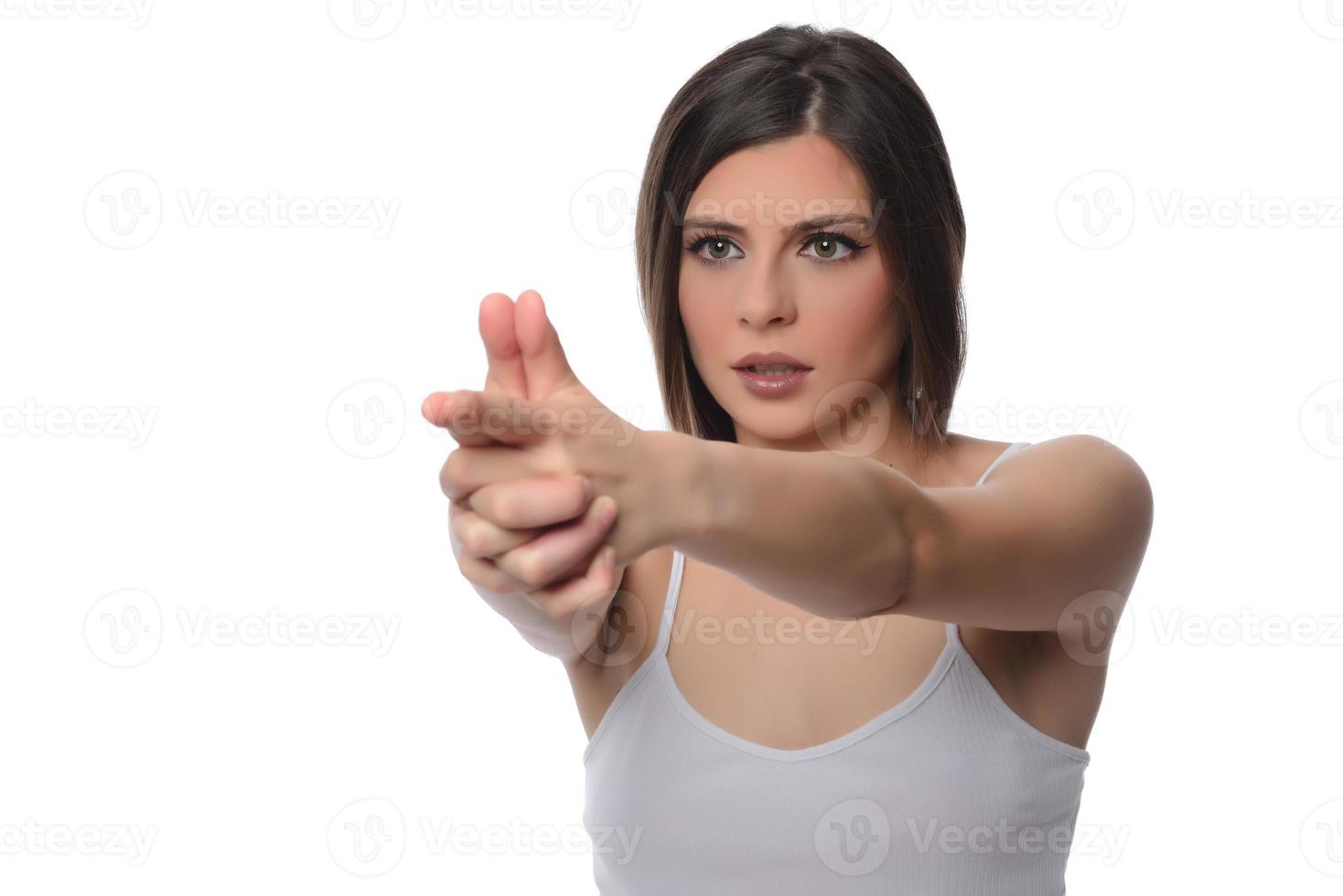 beautiful girl holding imaginary gun. isolated photo