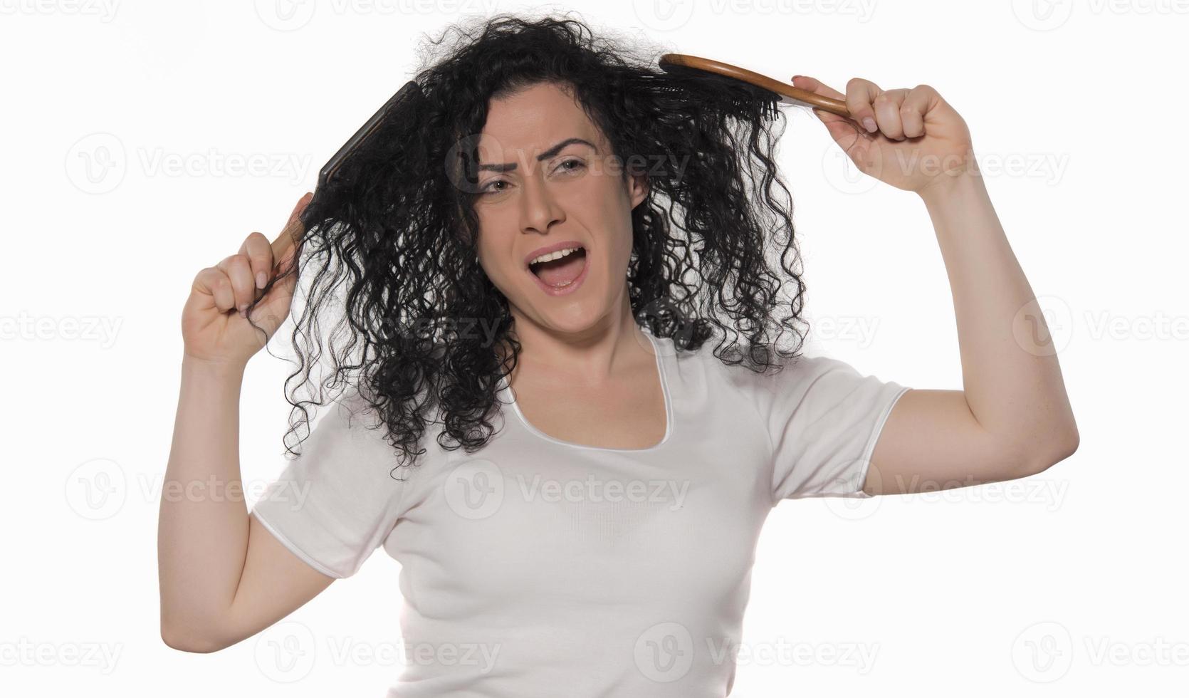 beautiful female with comb stuck in curly hair photo