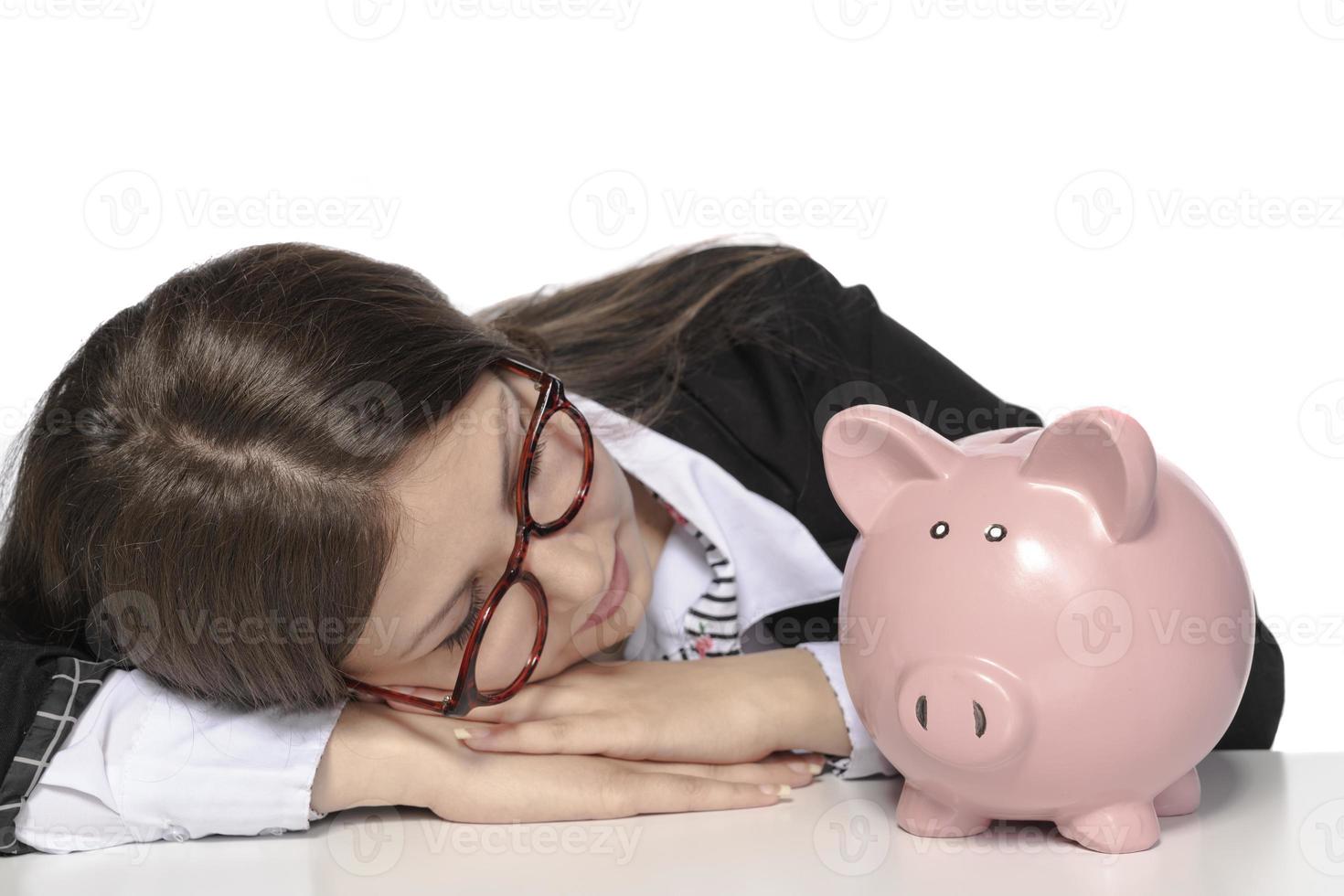 Woman Putting Coin In Piggy Bank photo