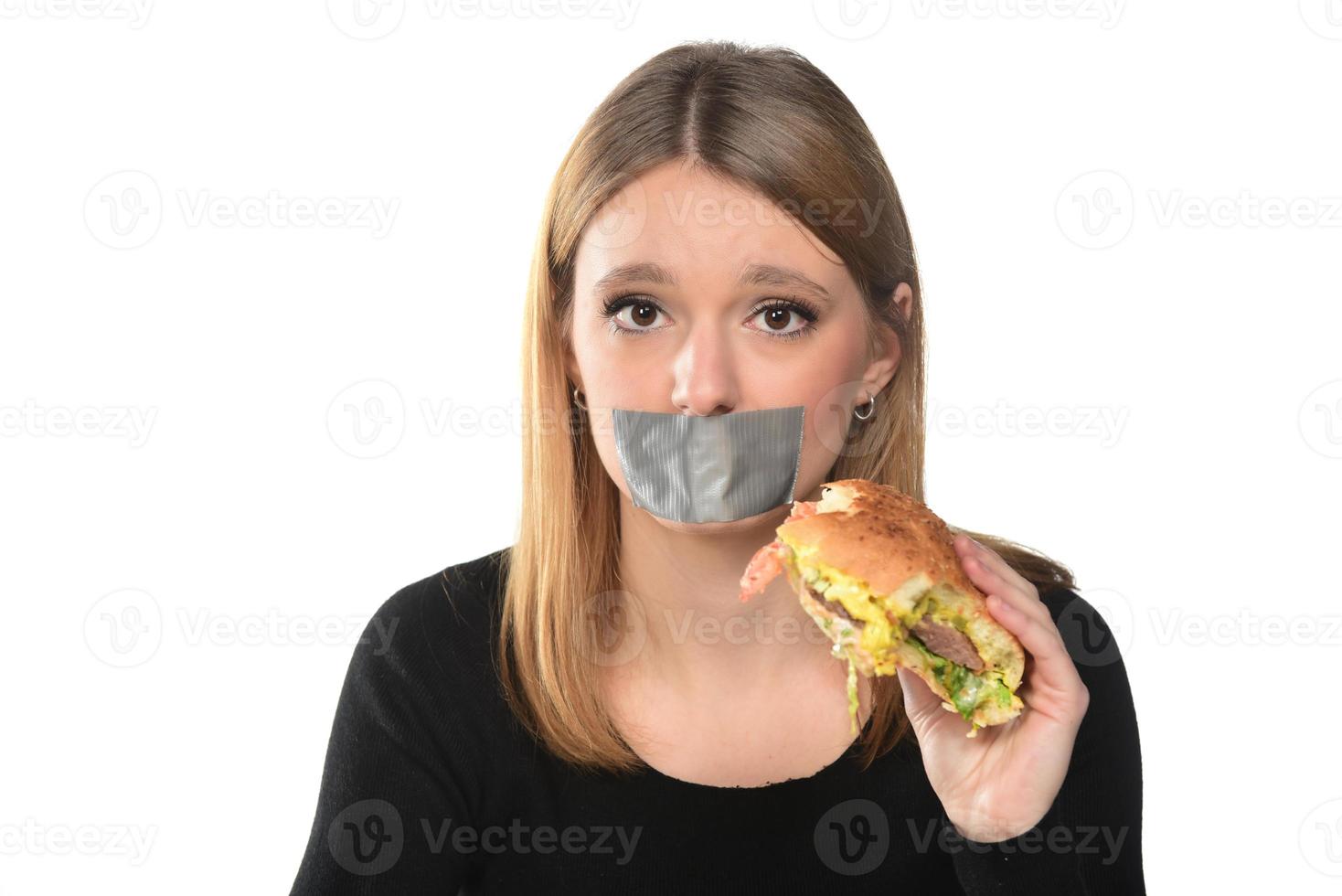 portrait of a beautiful funny young girl eating hamburger photo
