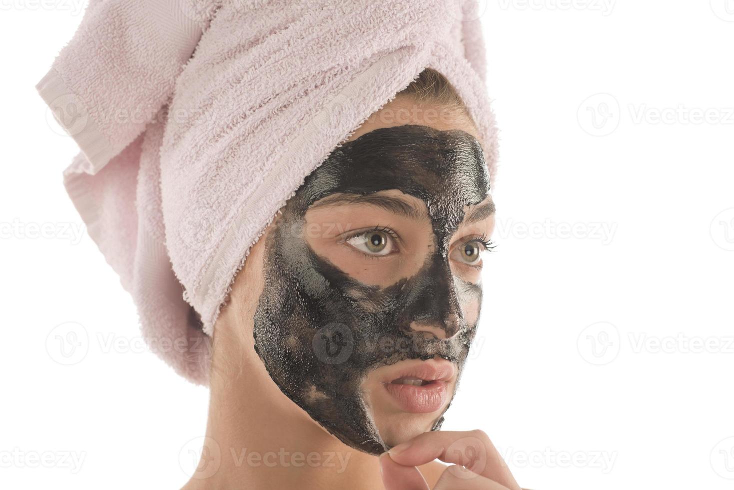 Black facial mask. beautiful girl with black cosmetic mask on her face. beauty concept photo