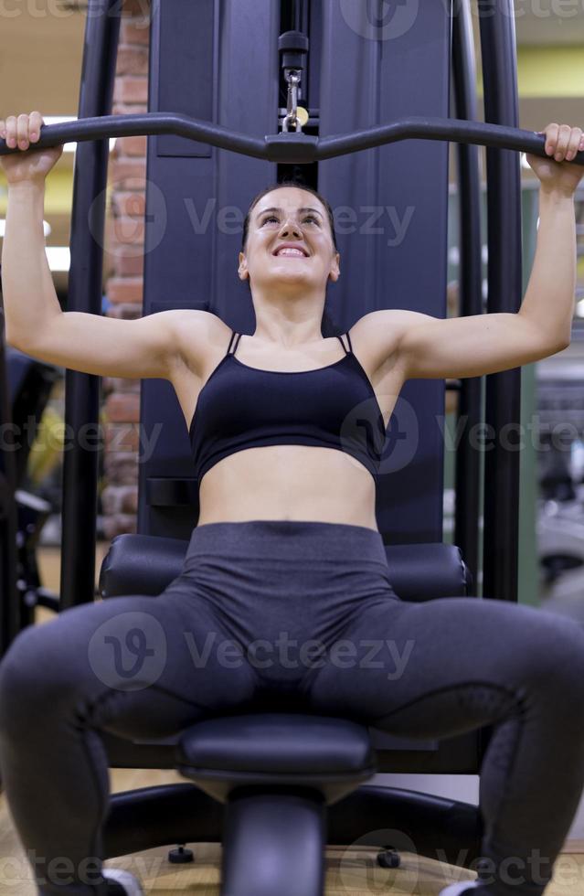 Woman doing a workout at the fitness gym. photo