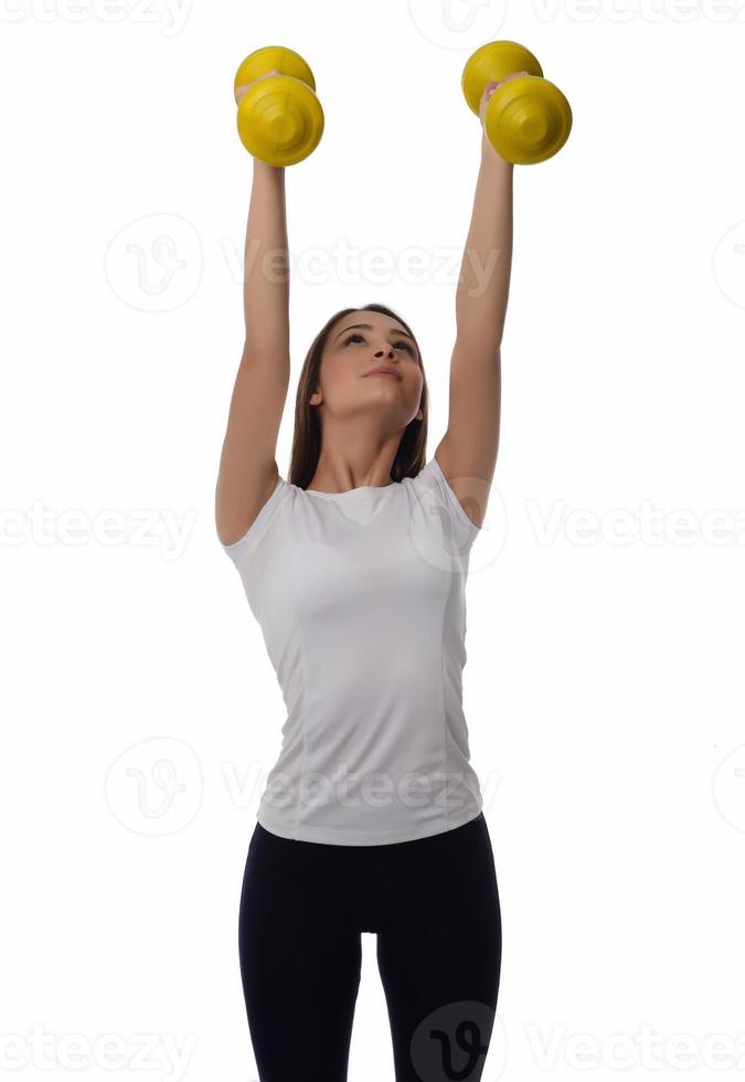 Determined woman losing weight and exercising with dumbbells photo