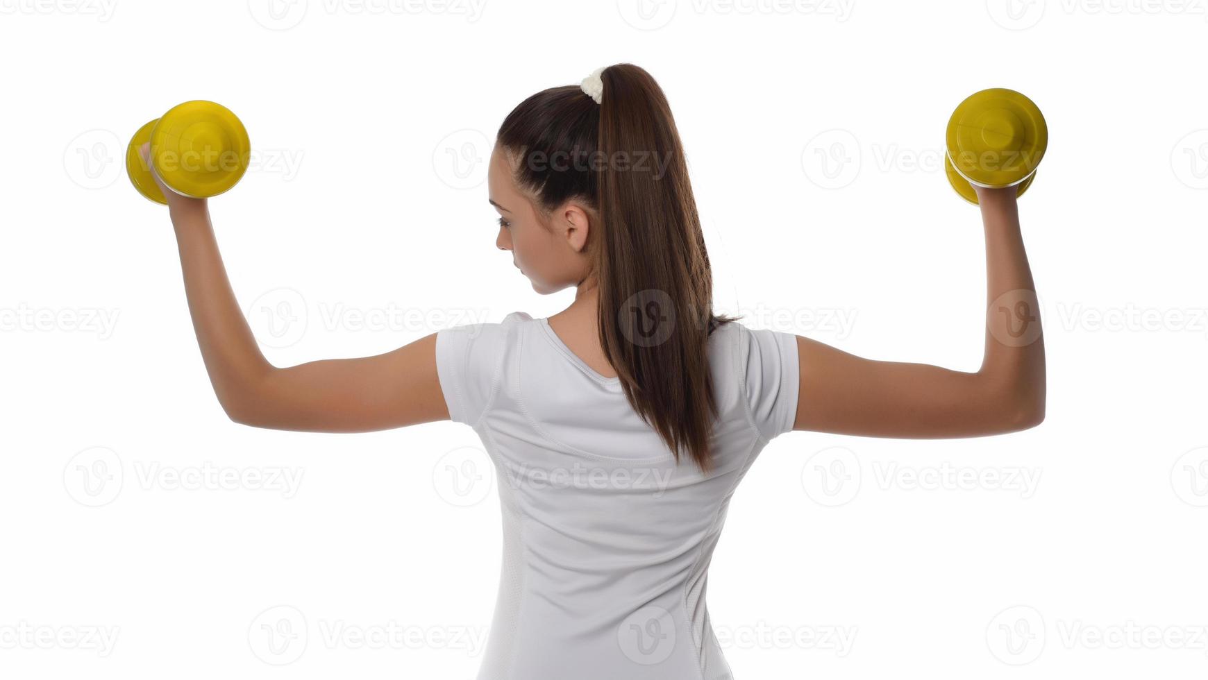 Determined woman losing weight and exercising with dumbbells photo