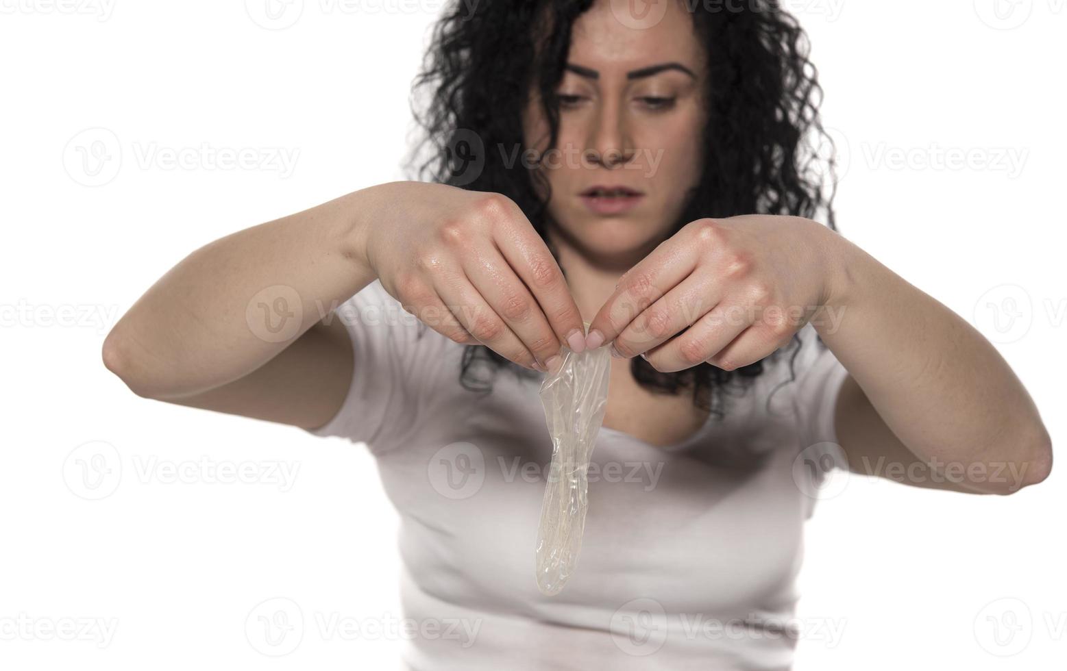 woman holding condom. save sex concept photo