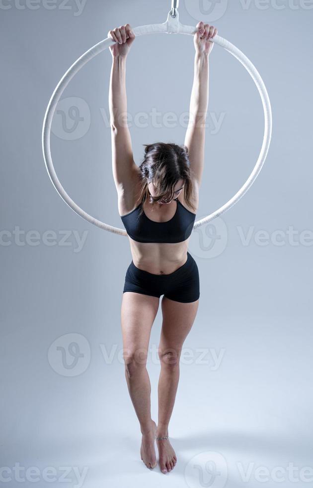 A female Aerial hoop gymnast  performing exercises on an Aerial hoop photo