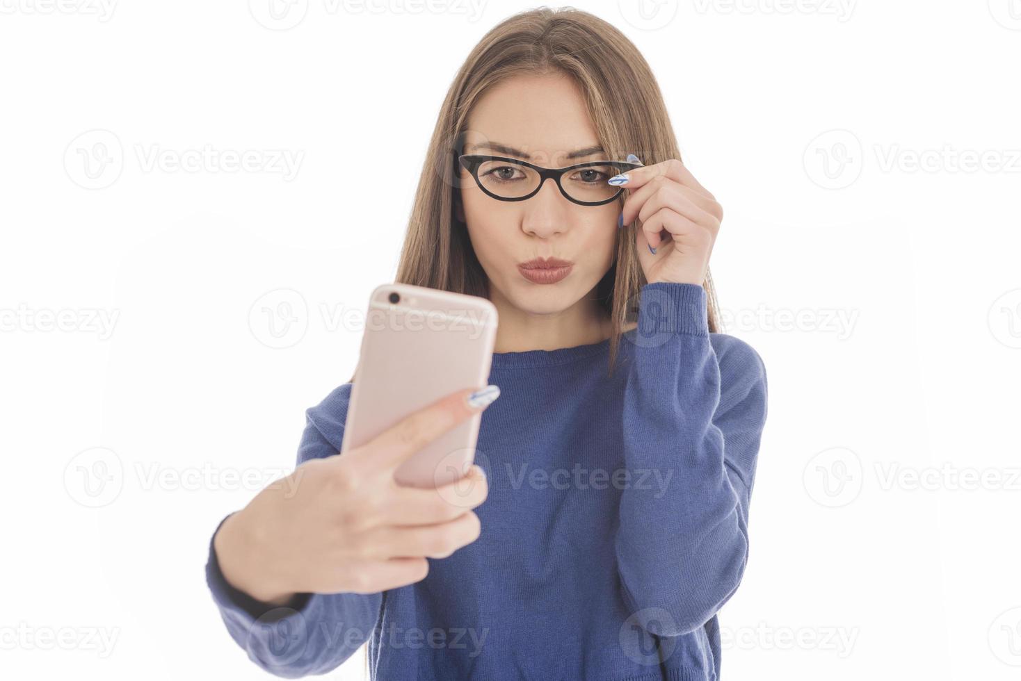 Beauty funny teenage girl making selfie with her cellphone photo