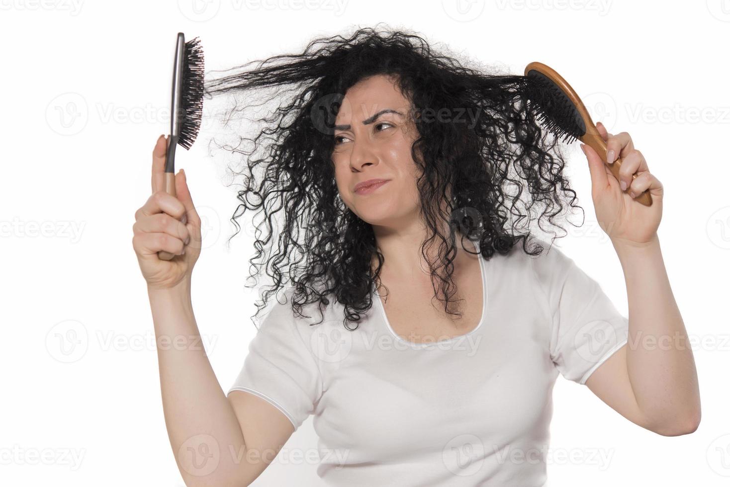 beautiful female with comb stuck in curly hair photo