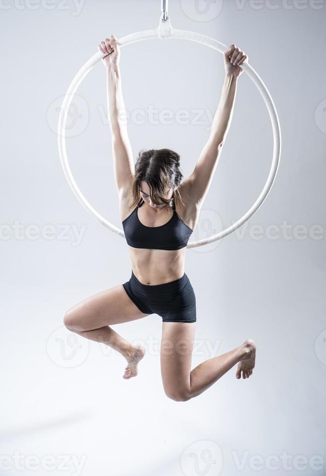 A female Aerial hoop gymnast  performing exercises on an Aerial hoop photo