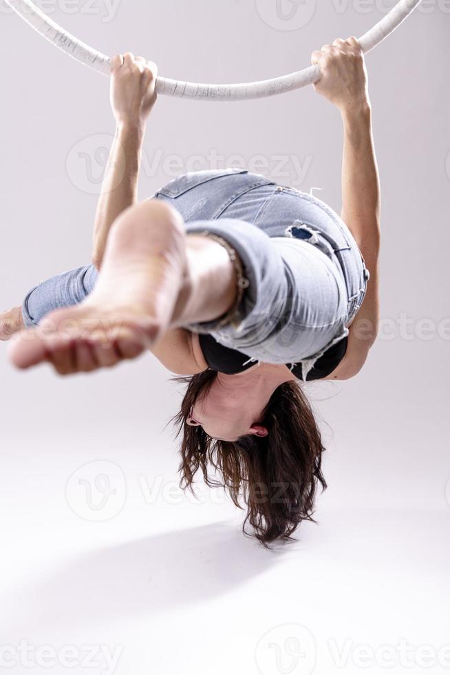 A female Aerial hoop gymnast  performing exercises on an Aerial hoop photo
