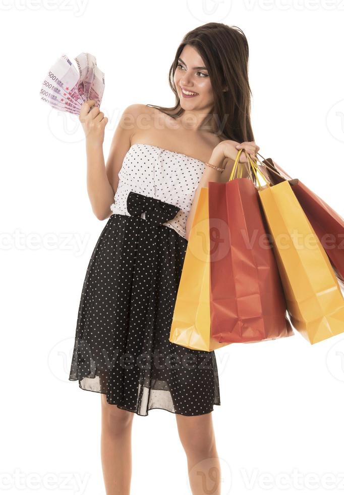 Young Modern Beautiful woman with a lot of shopping bags and money photo