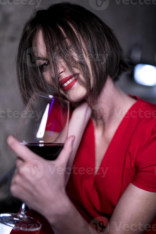 woman holding glass of red wine photo