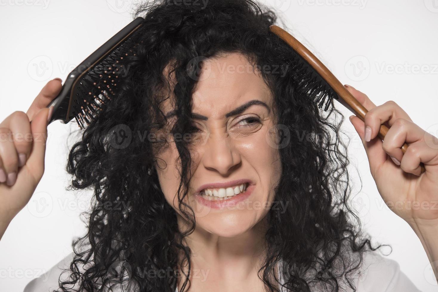 beautiful female with comb stuck in curly hair photo