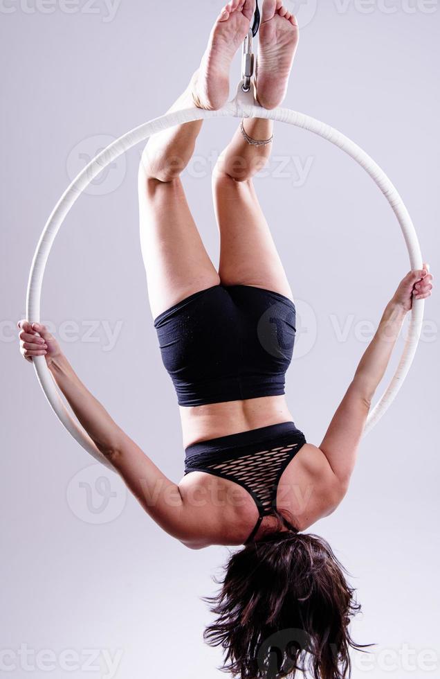 A female Aerial hoop gymnast  performing exercises on an Aerial hoop photo