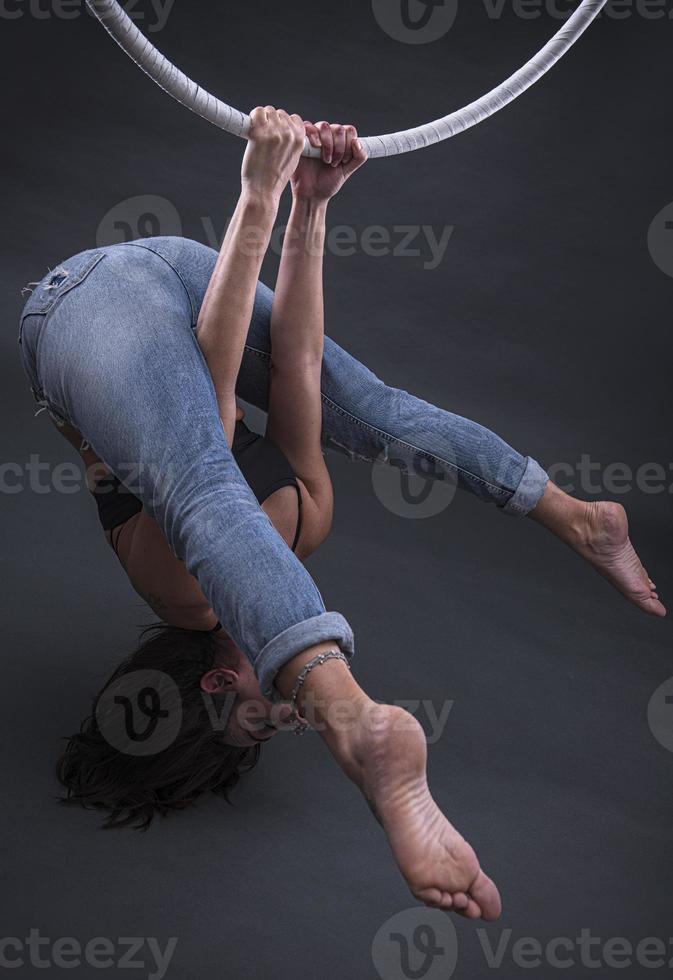 A female Aerial hoop gymnast  performing exercises on an Aerial hoop photo