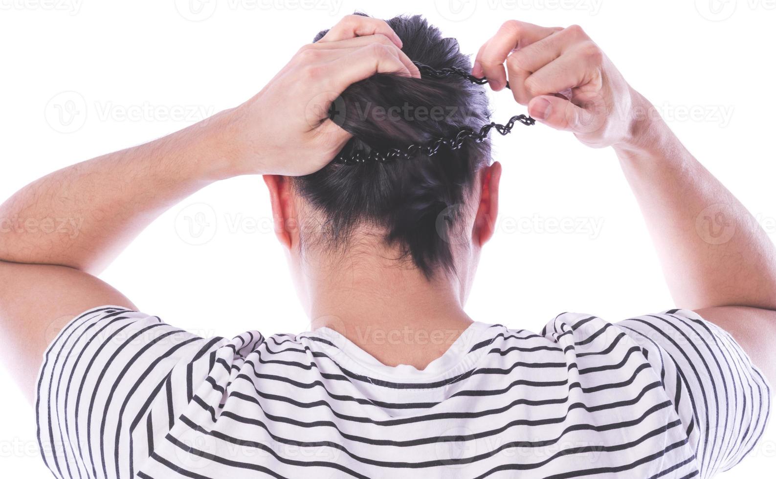 ack view of a man with long hair making ponytail. photo
