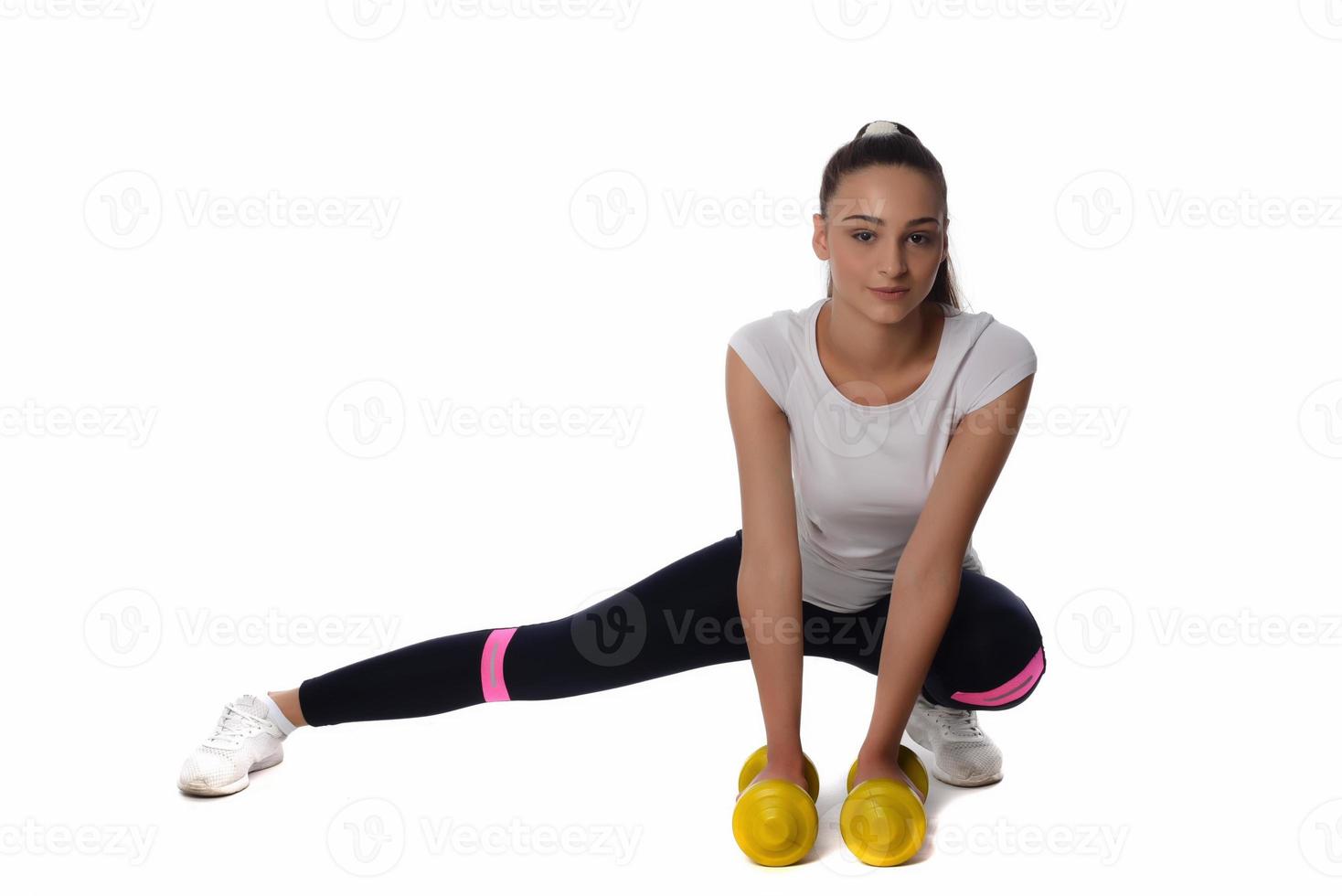 Determined woman losing weight and exercising with dumbbells photo