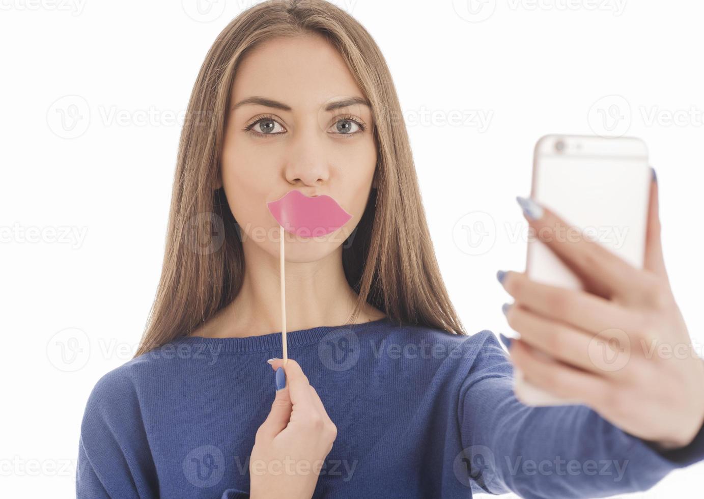 Beauty funny teenage girl making selfie with her cellphone photo