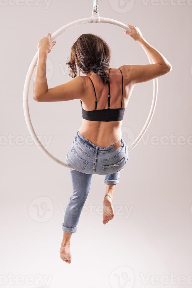 A female Aerial hoop gymnast  performing exercises on an Aerial hoop photo