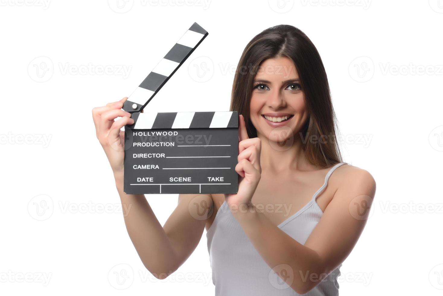 beautiful young woman with cinema clapper posing in studio. Movie concept. isolated photo