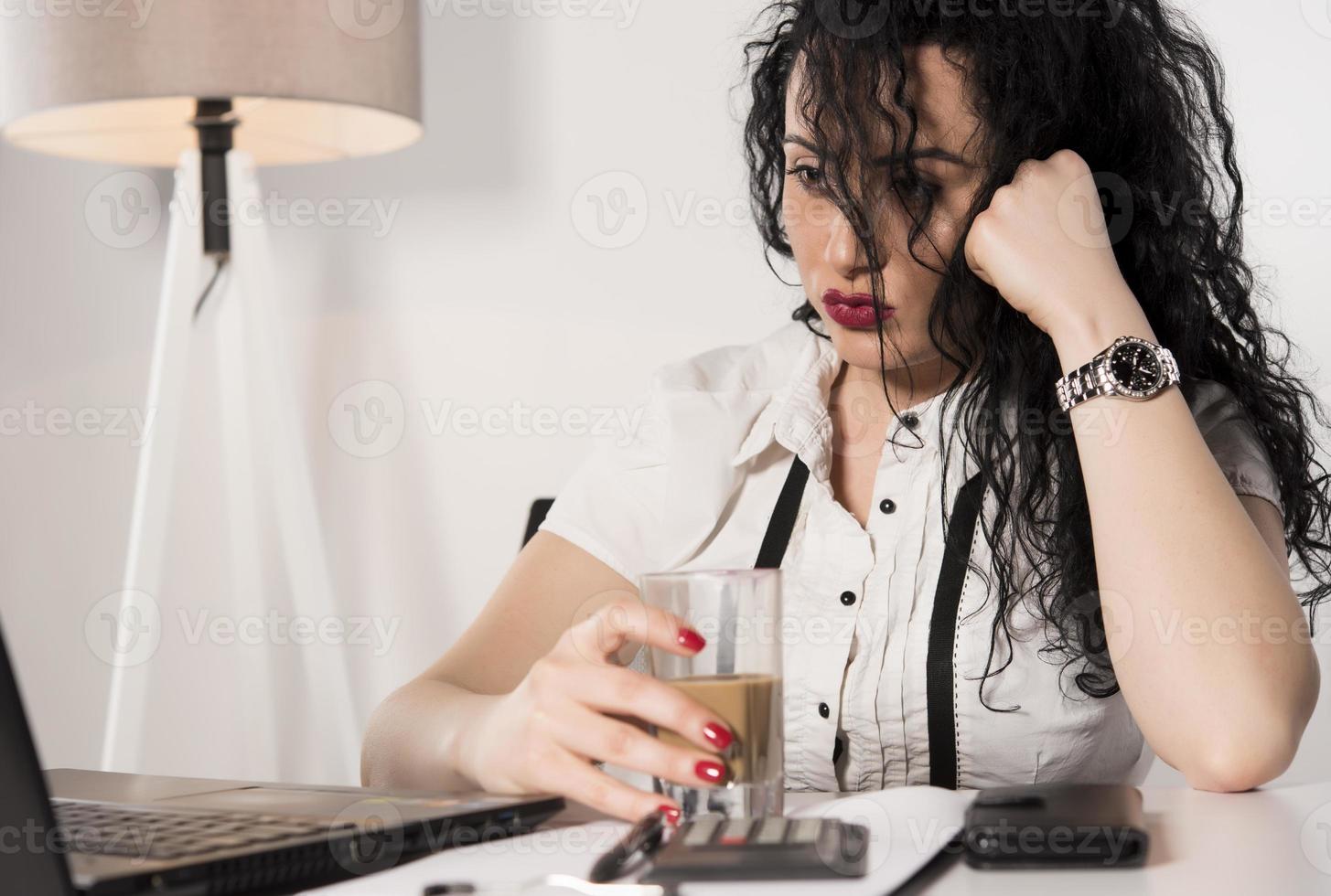 happy business woman trying to work in her office photo