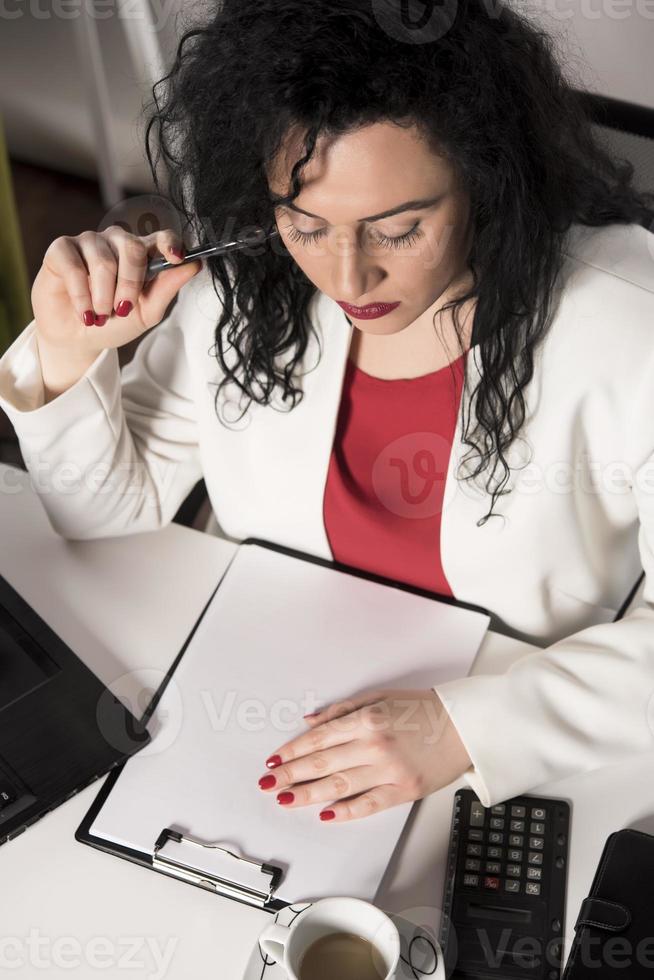 happy business woman trying to work in her office photo