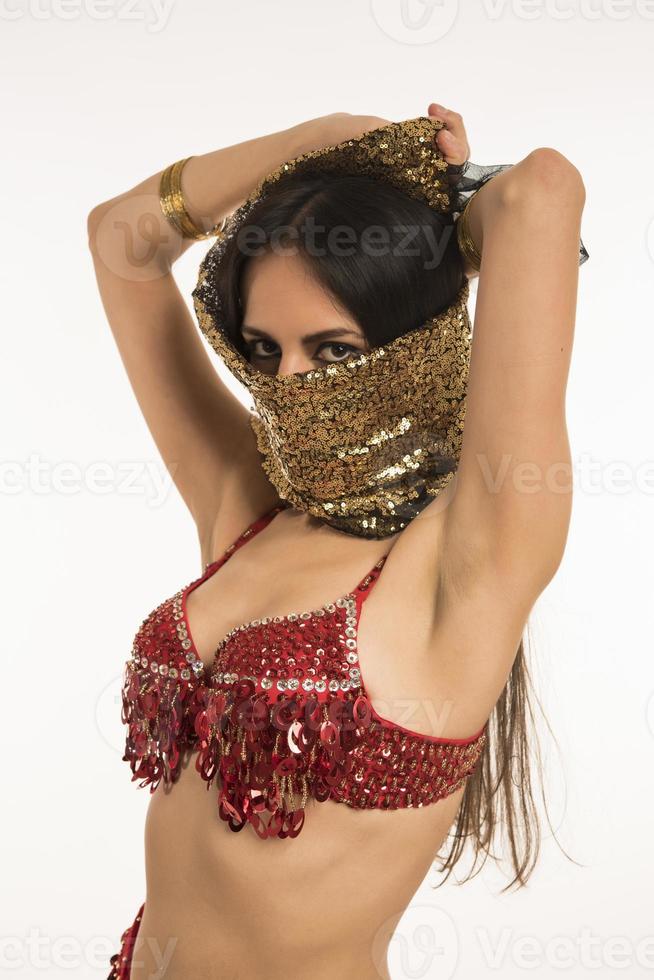 Beautiful belly dancer young woman in gorgeous red and black costume dress photo