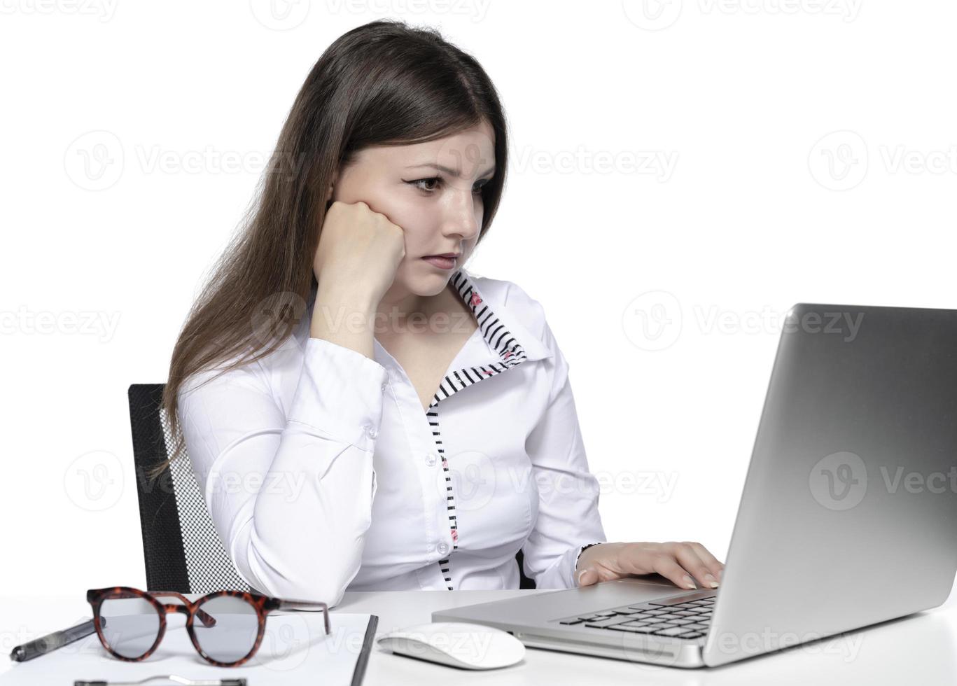 beautiful female model working on a laptop photo