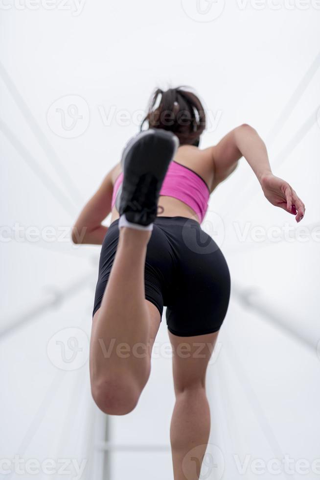 Sports Woman jogging down at urban outdoor trail. photo
