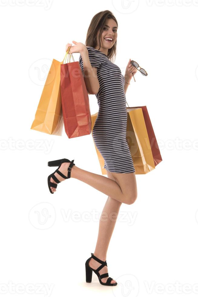 Young Modern Beautiful woman holding a lot of shopping bags photo