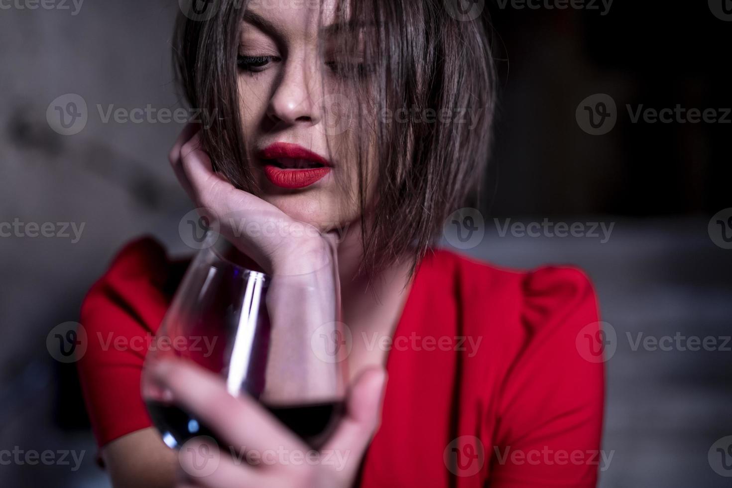 woman holding glass of red wine photo