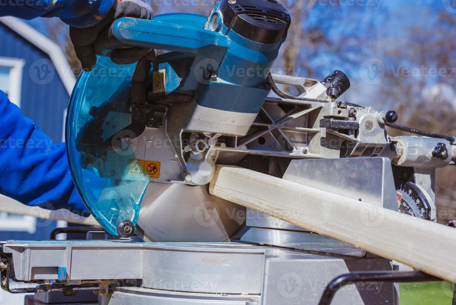 unknown construction worker using with circular saw and plank. construction concept photo