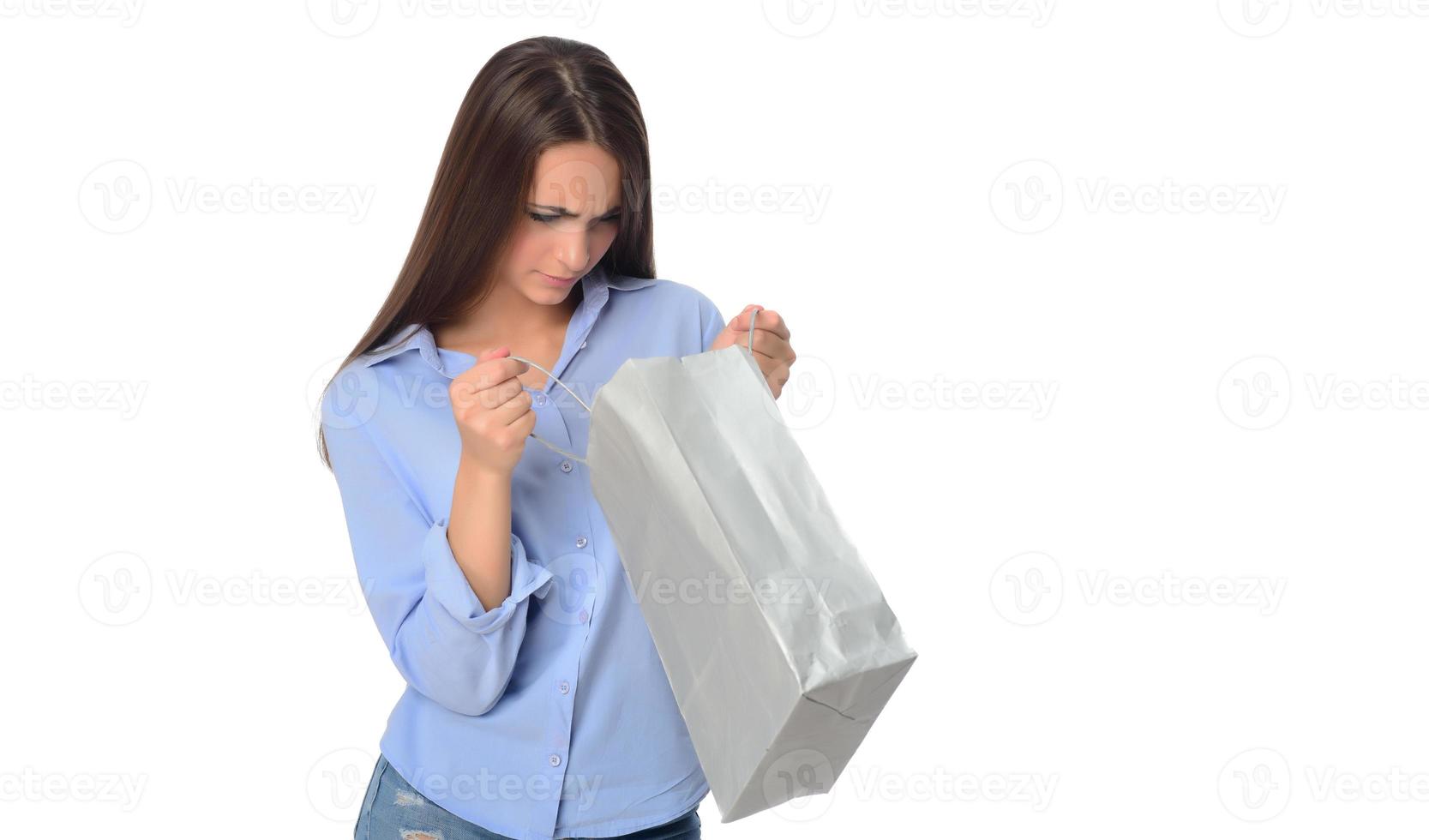 Shopping concept. Beautiful smiling brunette with shopping bags posing on white background photo