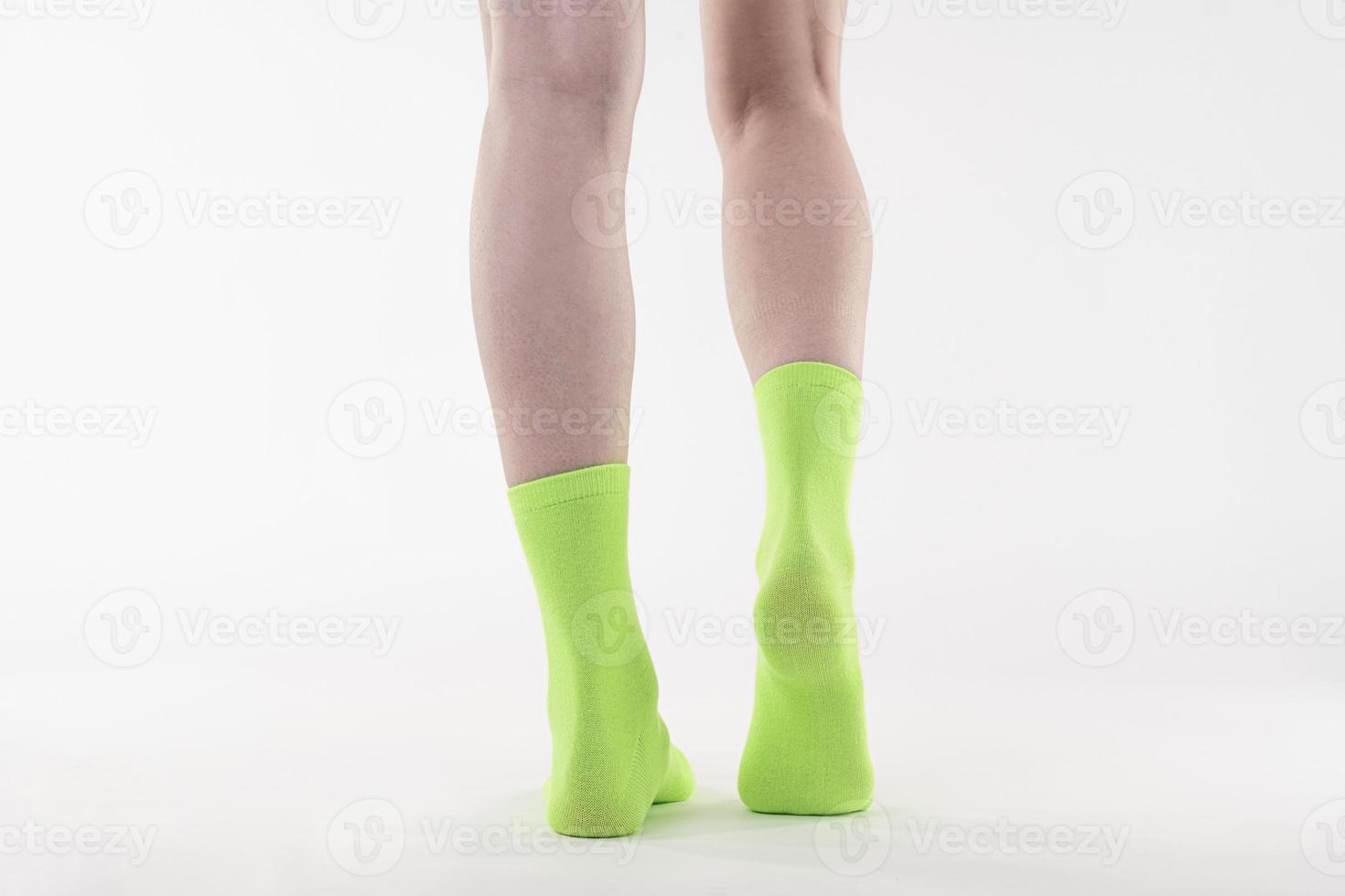 Nice attractive feminine long legs wearing green socks photo