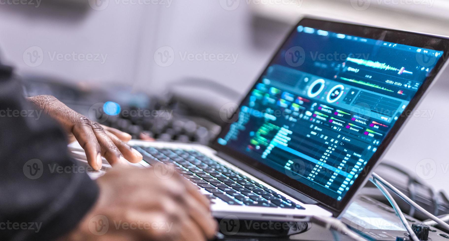 DJ plays live set and mixing music on laptop. Disc Jokey Hands on a laptop at club. 15987071