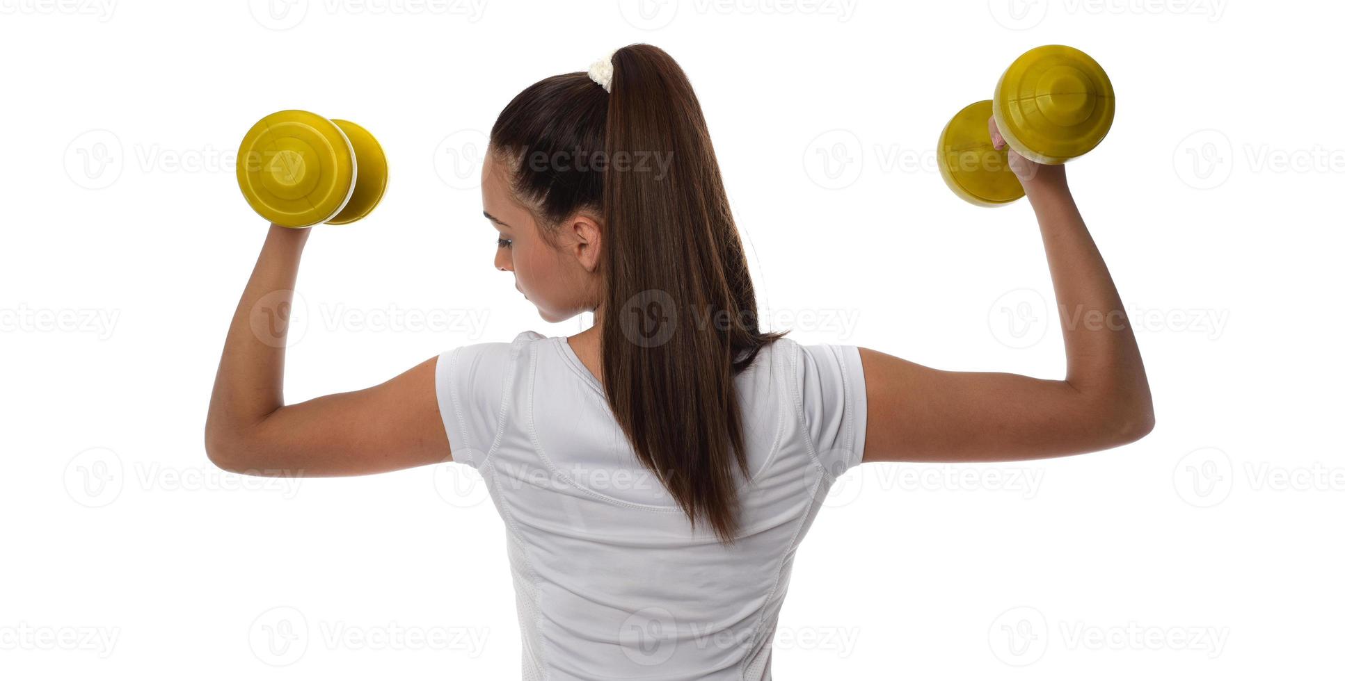 Determined woman losing weight and exercising with dumbbells photo