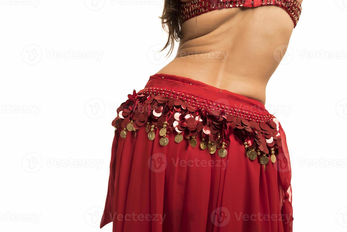 Beautiful belly dancer young woman in gorgeous red costume dress photo