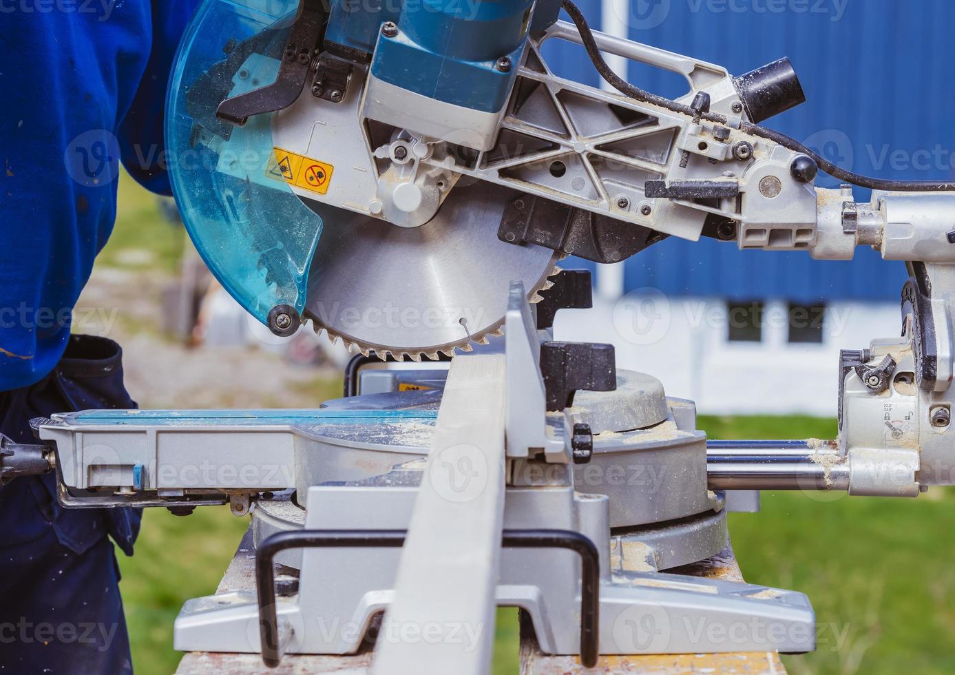 unknown construction worker using with circular saw and plank. construction concept photo