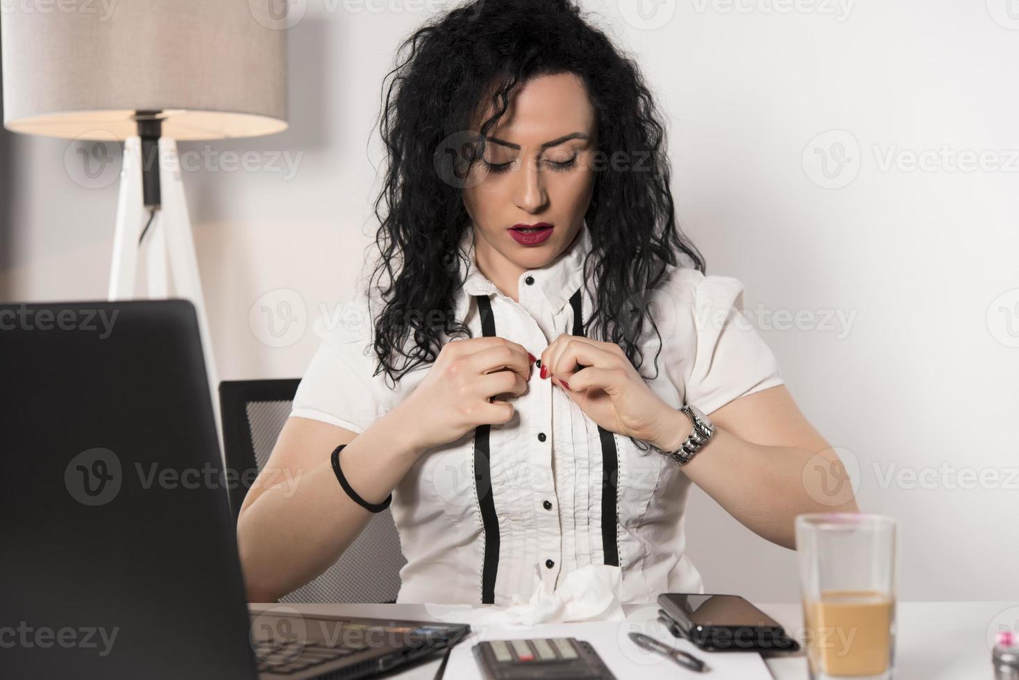 tired business woman trying to work in her office photo