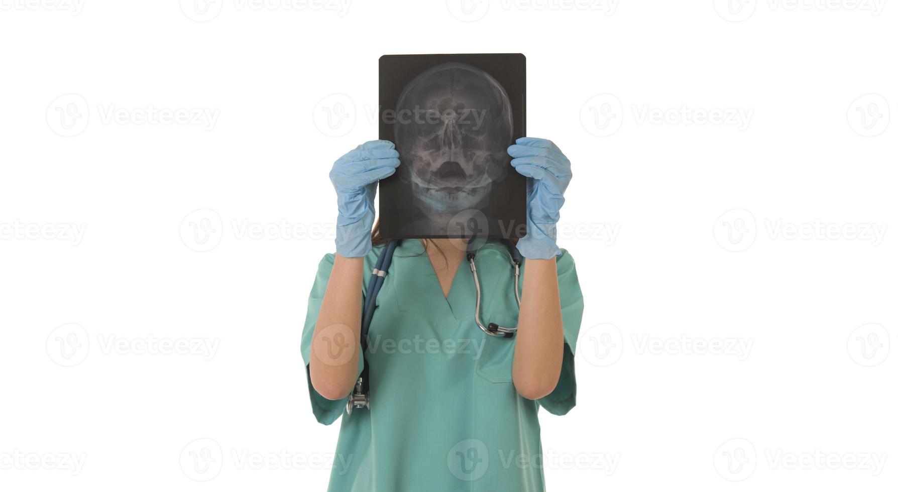 Young female doctor looking at the x-ray picture. isolated on white photo
