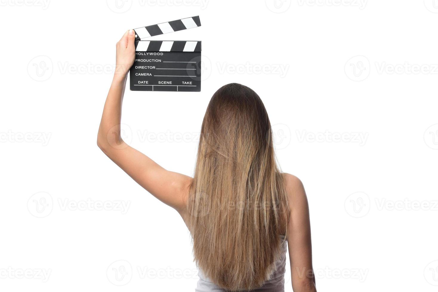 beautiful young woman with cinema clapper posing in studio. Movie concept. isolated photo