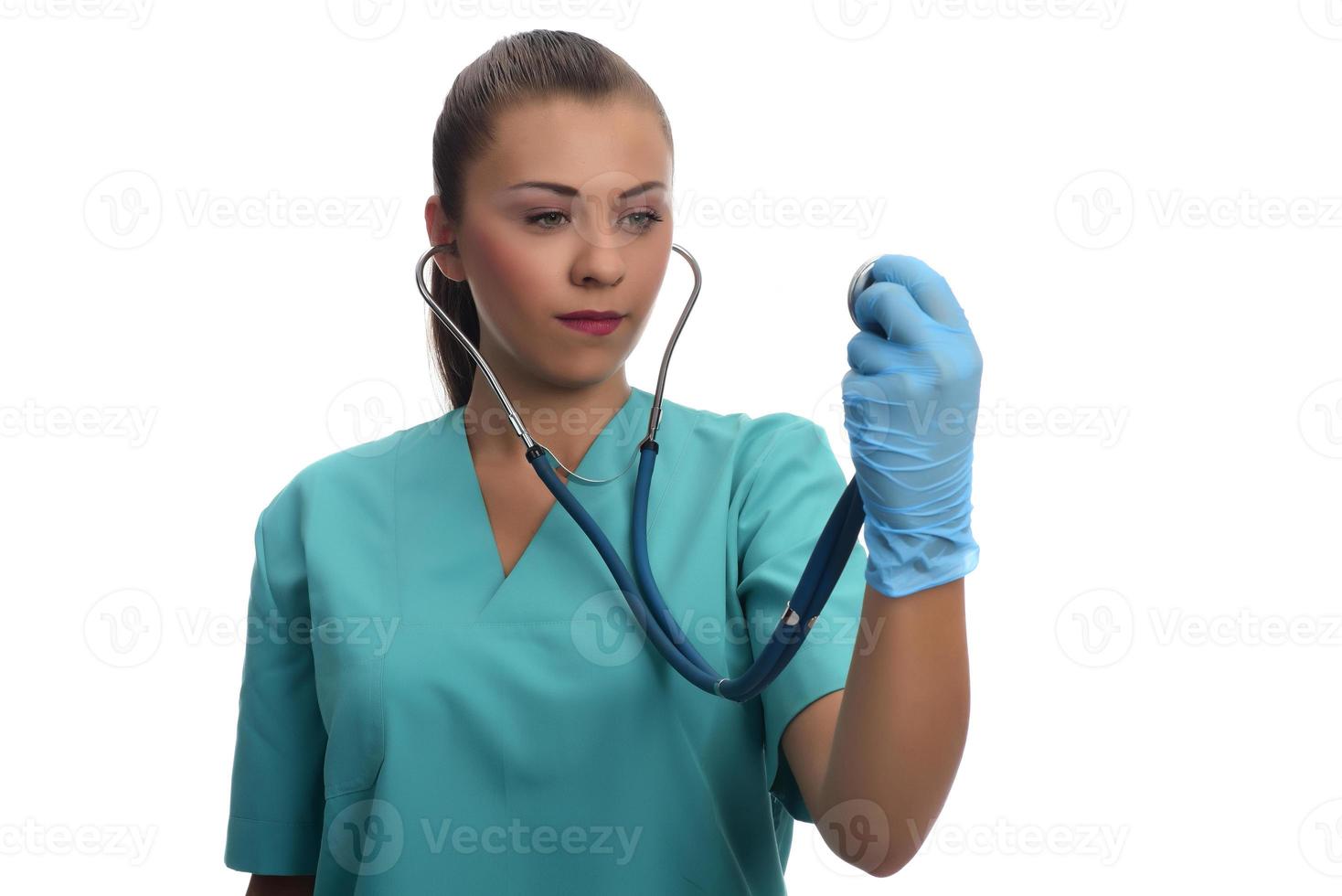 young female doctor holding stethoscope. isolated. photo