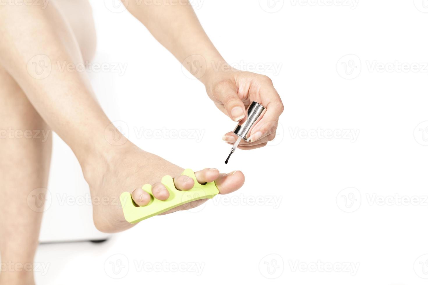 Foot spa. woman polishing nails. Foot care treatment at the beautician saloon. Woman at the beautician for pedicure. photo