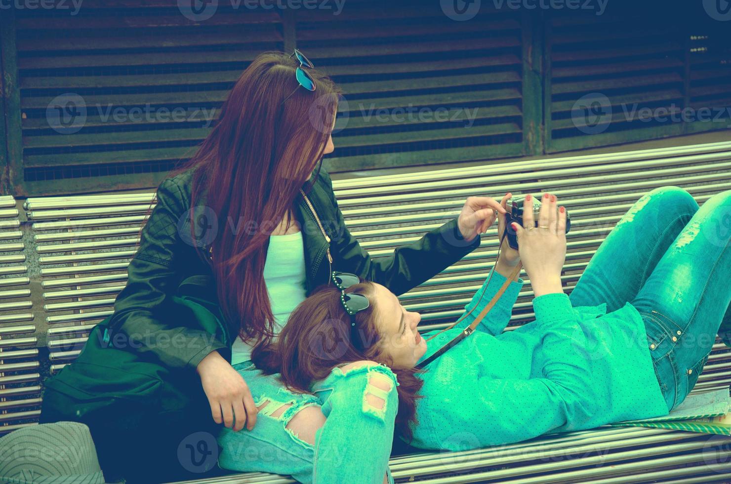 Girls resting on a bench in the city photo