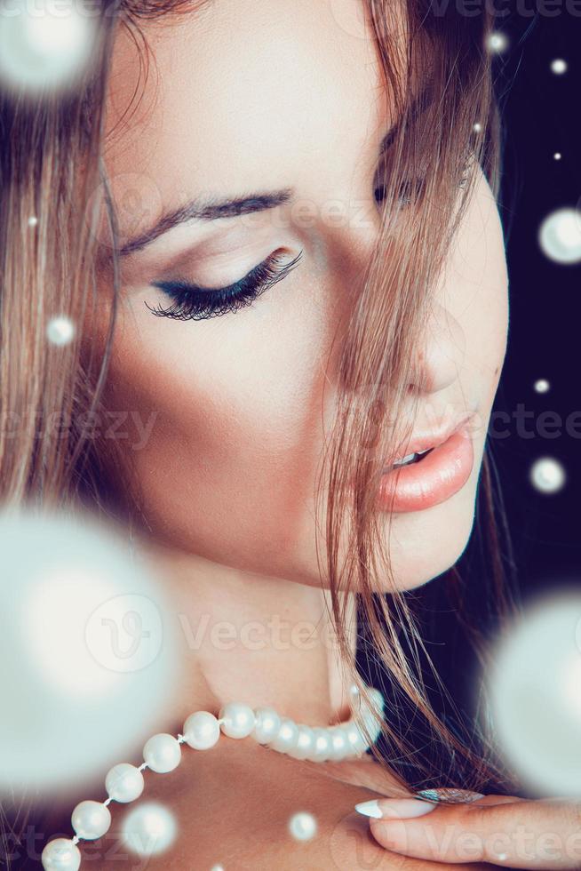 Portrait of female with lots of pearls photo