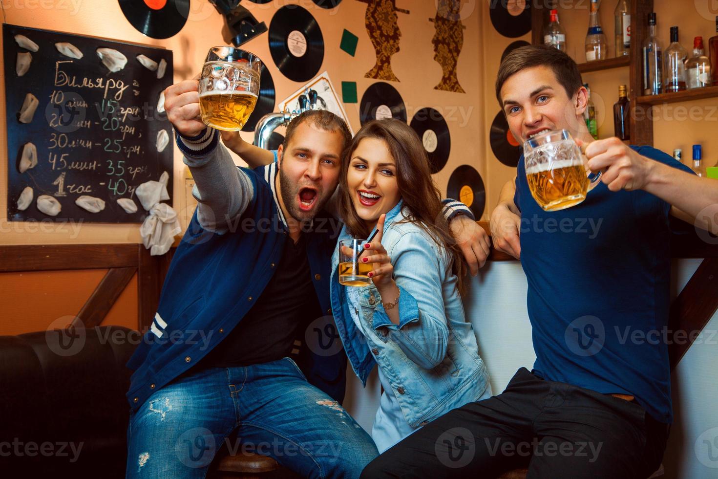 Friends having fun smiling and drink at the bar photo