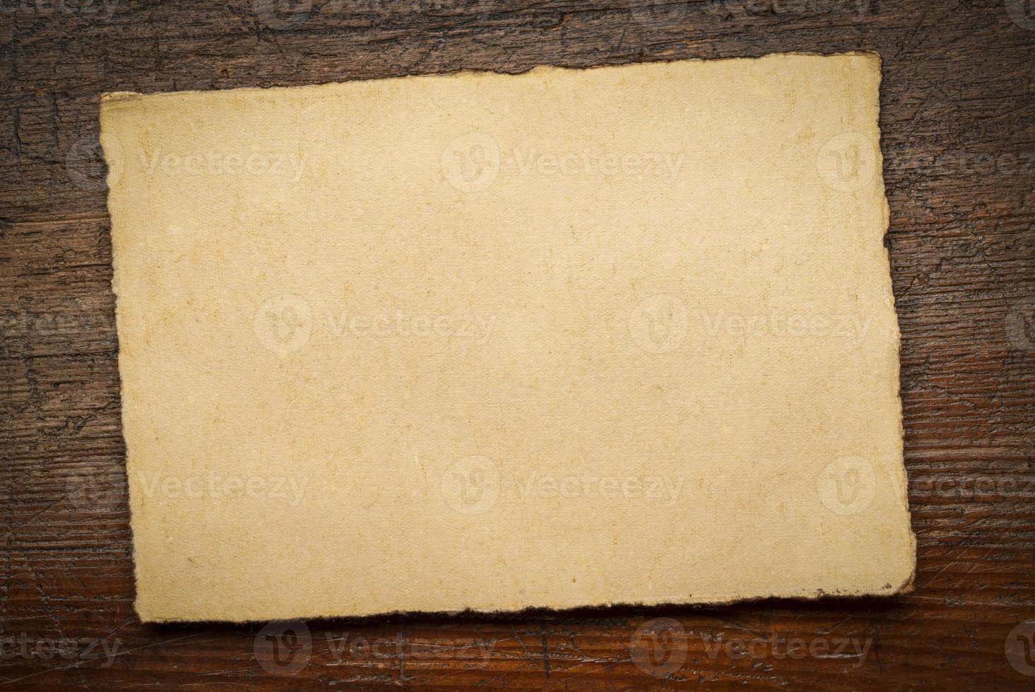 sheet of blank handmade paper with rough edges photo