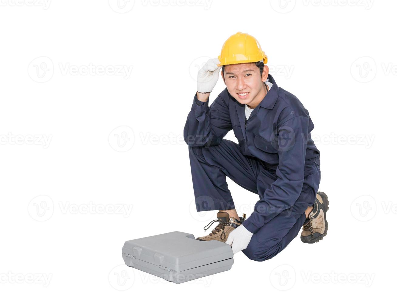 Young handyman sitting with his tool box photo